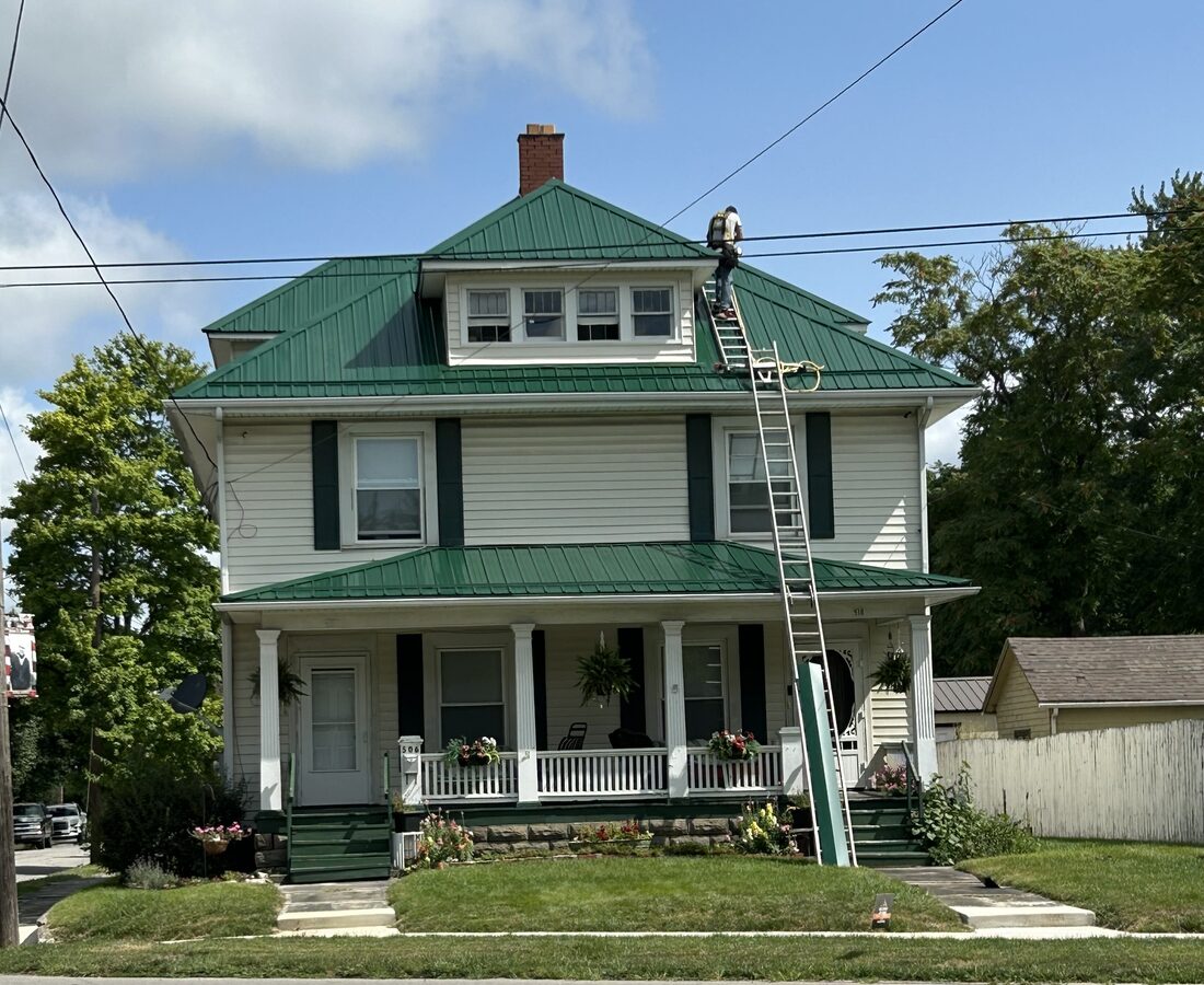 A new standing-seam metal roof on a two-story home